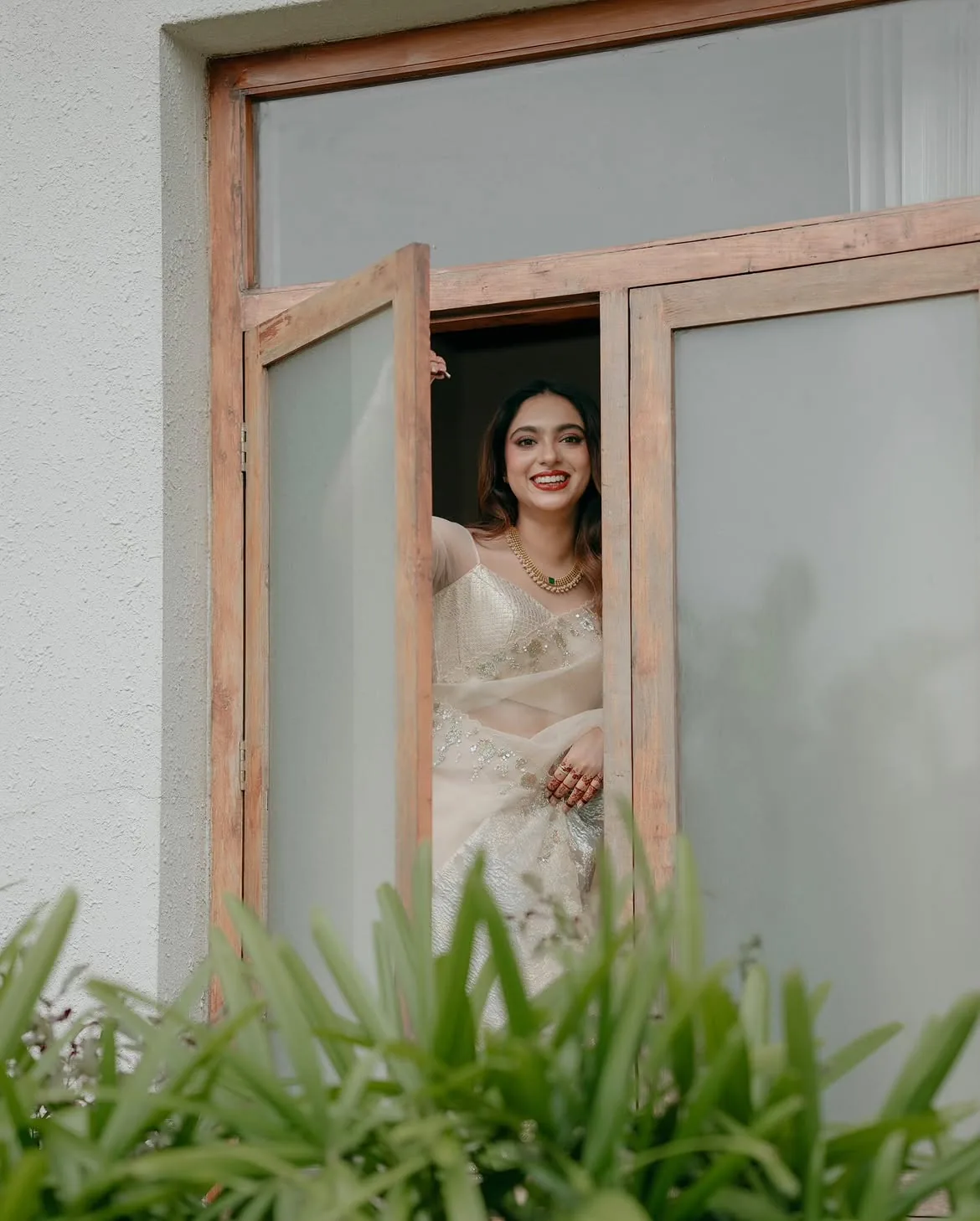 A joyful couple laughing together in a tropical garden